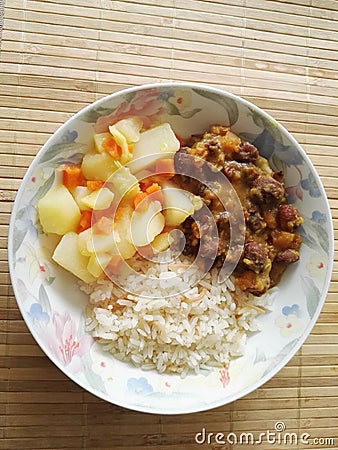 Plate of food with rice, beans and potato Stock Photo