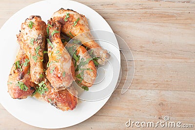 Plate with fresh chicken legs on wooden background Stock Photo