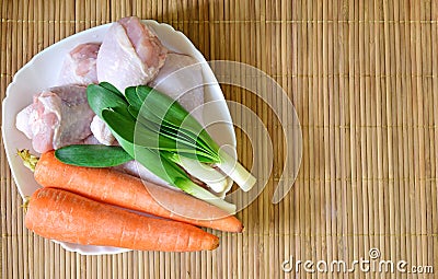 Plate with fresh vegetables and raw chicken legs. Stock Photo