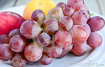 Plate full of fruits on table Stock Photo