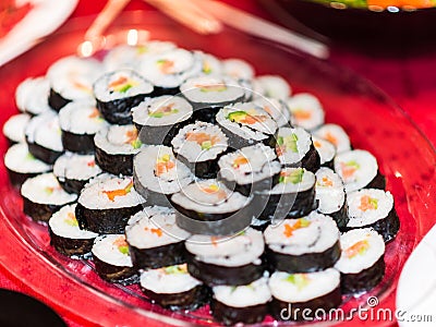 A plate full with salmon avocado sushi rolls. Stock Photo