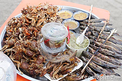 Plate of grilled crabs and fishes sold in a cambodian food market Stock Photo