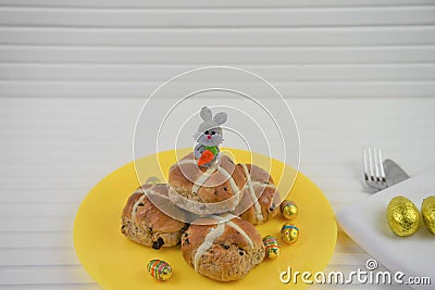 Plate of homemade hot cross buns and Easter bunny decoration Stock Photo