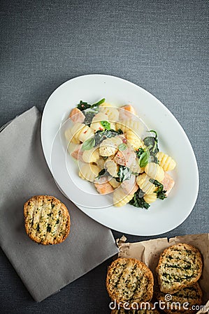 Plate of Italian gnocchi pasta and salmon Stock Photo