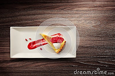 Plate of lemon tart with raspberry coulis Stock Photo