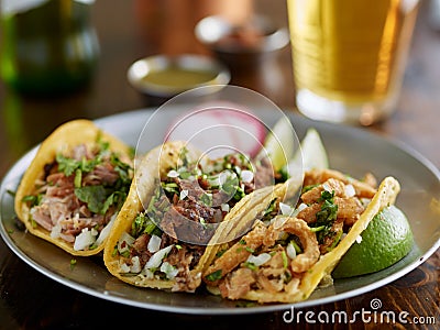 Plate of mexican street tacos garnished with cilantro and onion Stock Photo