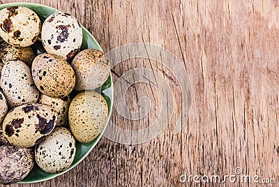 Plate with quail eggs on wooden board. Fresh eggs. Stock Photo