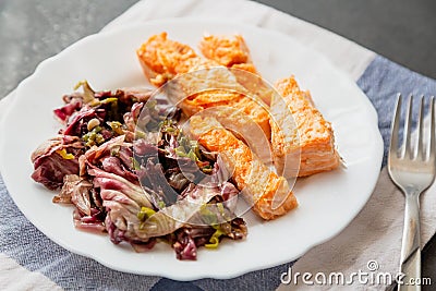 plate with salmon and red radicchio garnish Stock Photo