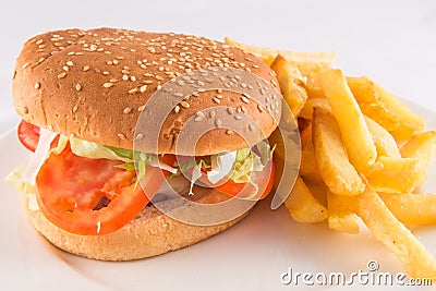 Plate with a simple burger with tomato, lettuce and potatoes Stock Photo