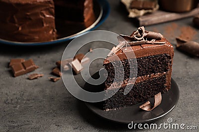 Plate with slice of tasty homemade chocolate cake on table. Space for text Stock Photo