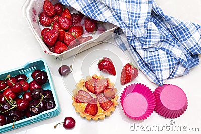 Plate of strawberry tart, cherry in basket. Stock Photo