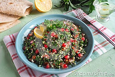 A plate of tabbouleh salad, close-up. Traditional Arabic food. Stock Photo