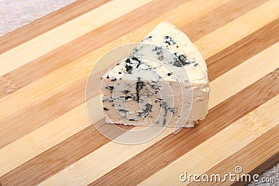 Plate with Tasty blue cheese on wooden table Stock Photo