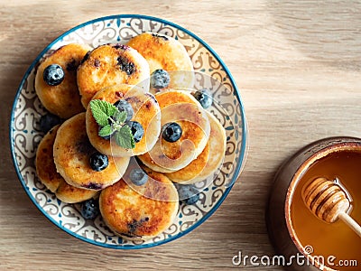 Plate with tasty fluffy pancakes with blueberries, honey Stock Photo