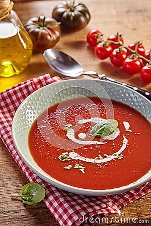 Plate of tomato cream soup. Rustic kitchen Stock Photo