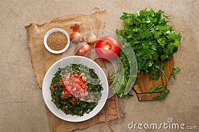 Plate of traditional Arabic salad tabbouleh on a wooden plate Stock Photo