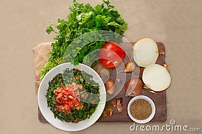 Plate of traditional Arabic salad tabbouleh on a wooden plate Stock Photo