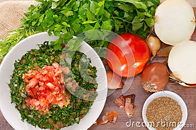 Plate of traditional Arabic salad tabbouleh on a wooden plate Stock Photo