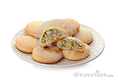 Plate with traditional cookies for Islamic holidays on white. Eid Mubarak Stock Photo