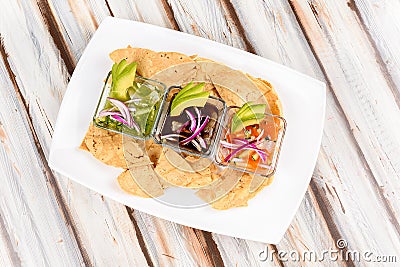 a plate with Various types of ceviche with avocado, onion and Mexican-style Stock Photo