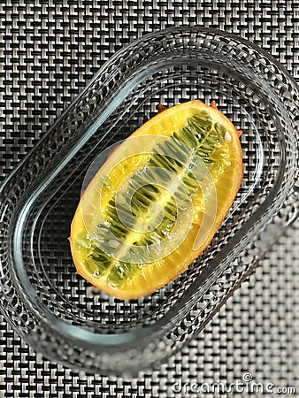 A Plated Horned Melon or Kiwano, also the African Horned Cucumber, Jelly Melon, Hedged Gourd, or Melano is a Beautiful Fruit Stock Photo