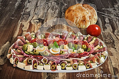 Plateful Of Traditional Serbian Appetizer Dish Meze With Pitta Bread And Tomato Set On Old Garden Table Surface Stock Photo