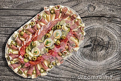 Plateful Of Traditional Appetizer Savory Dish Set On Old Knotted Cracked Wooden Picnic Table Stock Photo