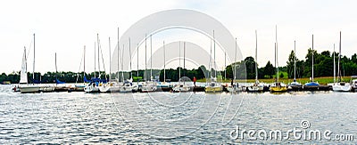Plateliai Lithuania 08 23 2020 Several sailing boats at a wooden pier on a lake Editorial Stock Photo