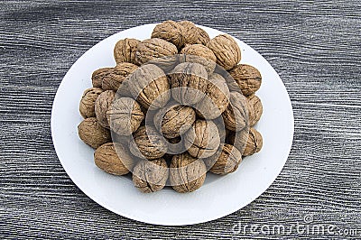 Plates of natural walnuts and walnut crumbs A plate of dry walnuts, the most wonderful walnut pictures Stock Photo