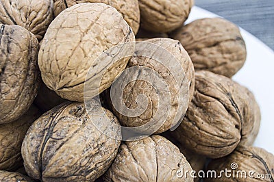 Plates of natural walnuts and walnut crumbs A plate of dry walnuts, the most wonderful walnut pictures Stock Photo