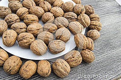 Plates of natural walnuts and walnut crumbs A plate of dry walnuts, the most wonderful walnut pictures Stock Photo