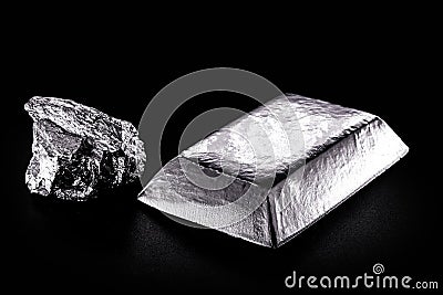 Platinum ingot and nugget, noble metal, used in the production of catalysts, luxury jewelry, isolated black background Stock Photo