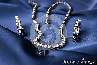 Platinum necklace and earrings with a diamond and blue precious Stock Photo