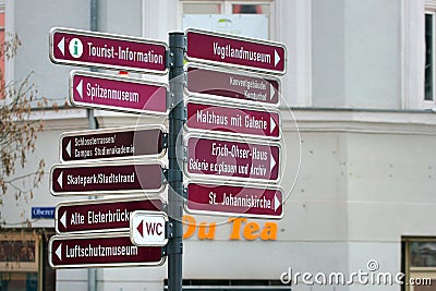 Plauen, Germany - March 28, 2023: Tourist information signpost on Town hall square with arrows pointing to main attractions of Editorial Stock Photo