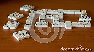 Play Dominoes on a wooden background. Gamble. Stock Photo