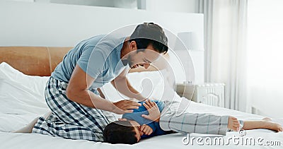 Play, father and son with love, bed and fun with happiness, quality time and energy on a weekend break. Male parent, boy Stock Photo