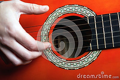 Play with fingers fingering strings on a classic acoustic guitar. live music concept Stock Photo