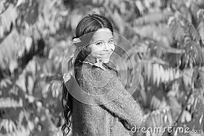 Play more get happy. Small child happy smiling on autumnal landscape. little girl wear autumn leaves in hair. Enjoying Stock Photo