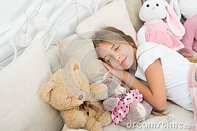 Play soft toy before go sleep. Sleep with toy. Carefree childhood. Relaxing before sleep. Girl enjoy evening time with Stock Photo