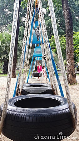 Children playing swing toys. Editorial Stock Photo