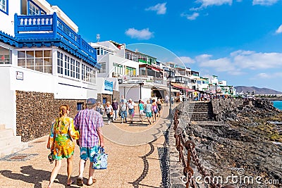 PLAYA BLANCA, SPAIN - DEC 14: Seaside promenade in Playa Blanca, the former fishermens village became a main touristic spot with Editorial Stock Photo