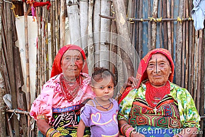 Playa Chico village, Panama - August, 4, 2014: Three generations of kuna indian women in native attire sell handcraft clothes Editorial Stock Photo