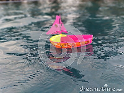 Play boat by a kid during the rains Stock Photo