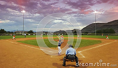 A Player Bats in a Twilight Baseball Game Editorial Stock Photo