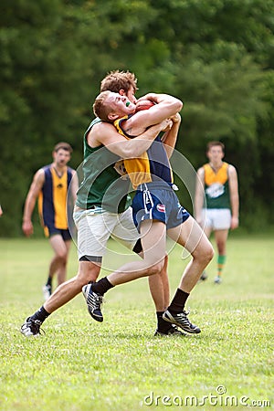 Player Grimaces While Being Tackled In Australian Rules Football Game Editorial Stock Photo