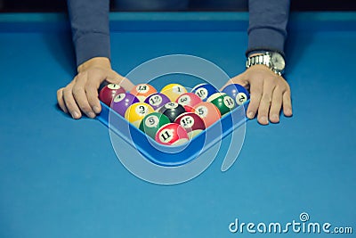 Player using triangle to preparing the balls for the next game Stock Photo