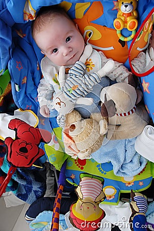 Playful baby surrounded by toys Stock Photo