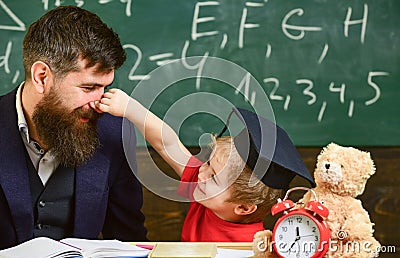 Playful child concept. Kid cheerful play with dad. Father with beard, teacher teaches son, little boy, while child Stock Photo