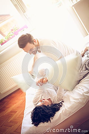 Playful couple in bed. Funny morning. Stock Photo