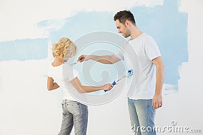 Playful couple painting each other in new house Stock Photo